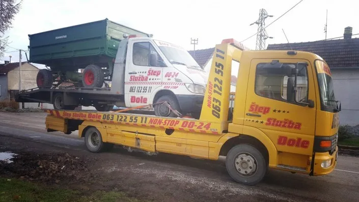 Šlep služba Djole sa žutim šleperom šlepa beli šlep koji kosi prikolicu